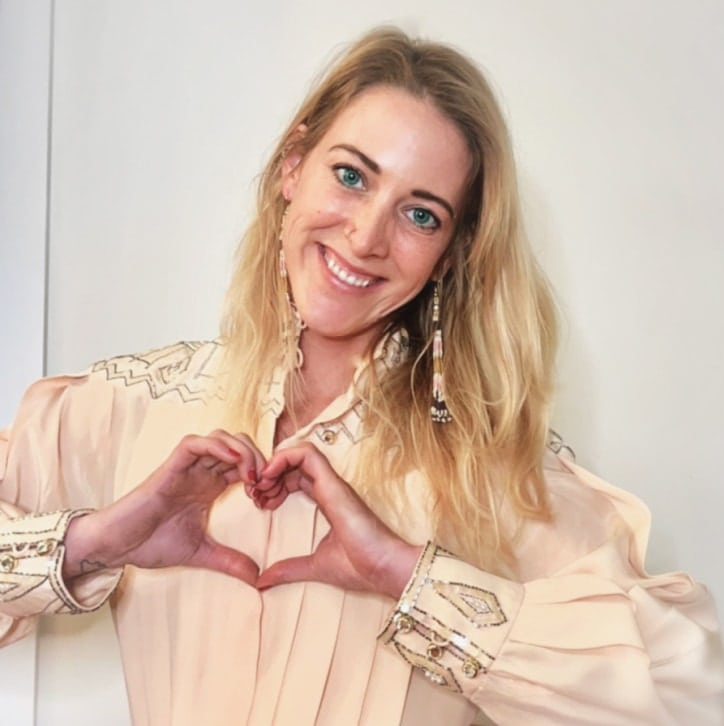 Dr. Alexandra Cope smiling and making a heart with her hands