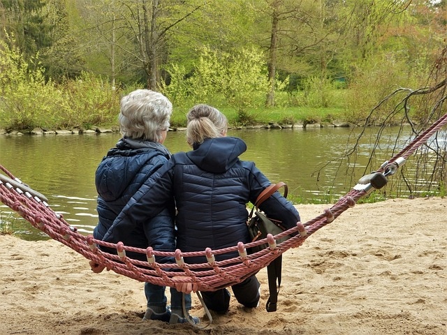 2 women sitting on hammock of elder generation